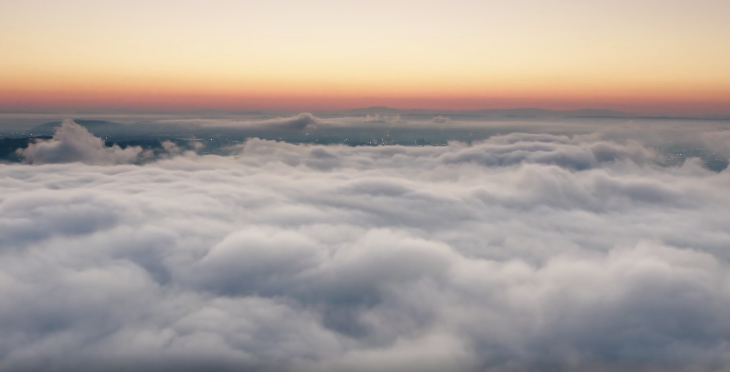 above the clouds at sunset